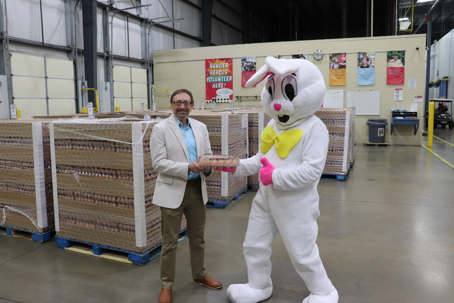 Ozarks Food Harvest CEO Bart Brown receives an annual Easter holiday donation from Opal Foods.
